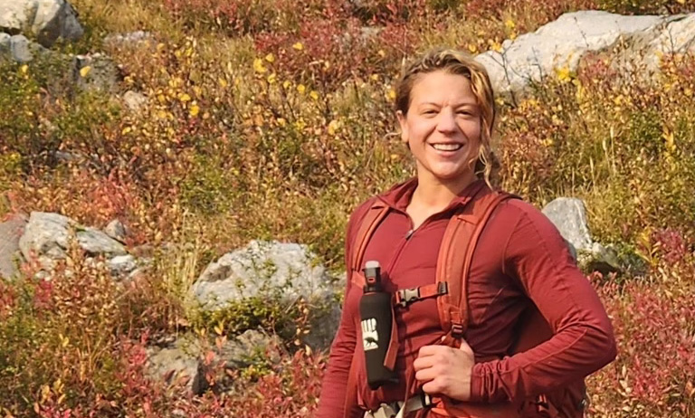 Woman hiking with bear spray