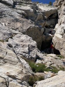 Men scrambling up rocks