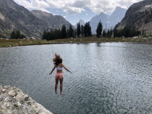 Woman jumps into a mountain lake