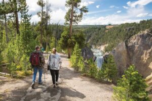 Hikers of a trail above a waterfall