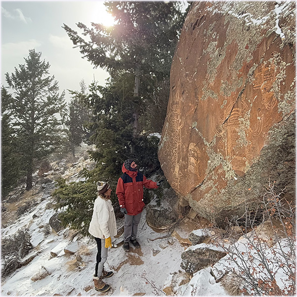 Hikers looking at petroglyphs in the Torrey Valley